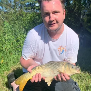 Matt, who loved fishing, holding a fish