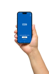 Nhs app, which can deliver alerts when prescriptions are ready, on a smart phone being held by a hand